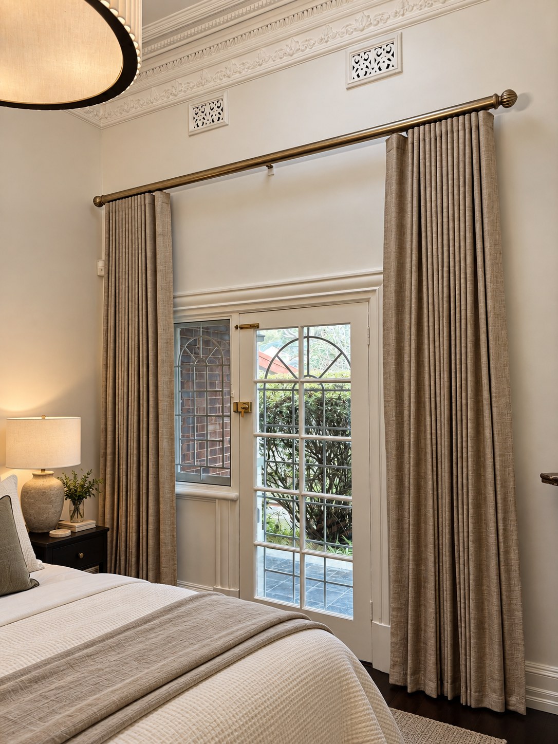 Tailored blockout curtains framing French doors in a bedroom