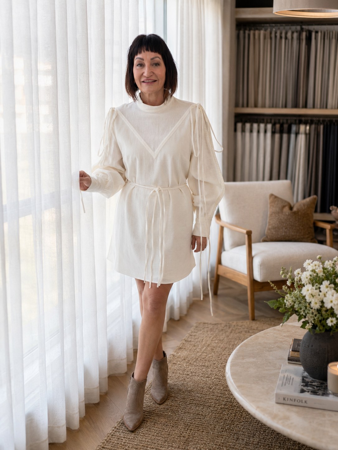 Clare Holland standing beside sheer curtains in the showroom