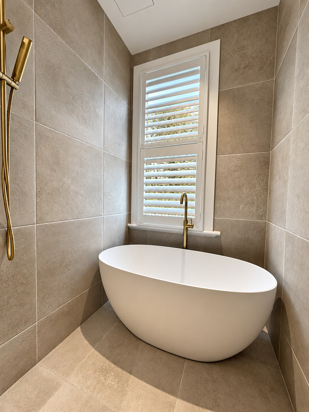 White wet-area plantation shutters above a freestanding bath